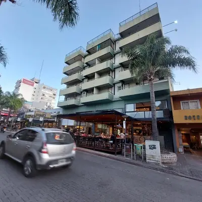 a car driving down a street in front of a building at Monoambiente centro Carlos Paz in Villa Carlos Paz