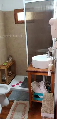 a bathroom with a sink and a mirror at Cabaña Alma in Villa Carlos Paz