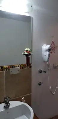 a bathroom with a sink and a blow dryer at Cabaña Alma in Villa Carlos Paz