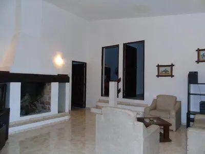 a living room with a couch and a fireplace at Hermosa propiedad para 8 y 10 personas piscina quincho gran parque in Cavalango