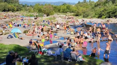 a large group of people sitting on the beach at Casa en Cabalango para 10 personas in Cavalango