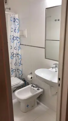 a bathroom with a sink and a toilet and a mirror at Nueva Córdoba Temporario in Cordoba
