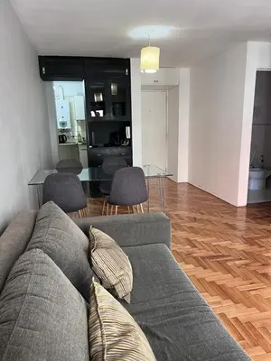 a living room with a couch and a table at Nueva Córdoba Temporario in Cordoba