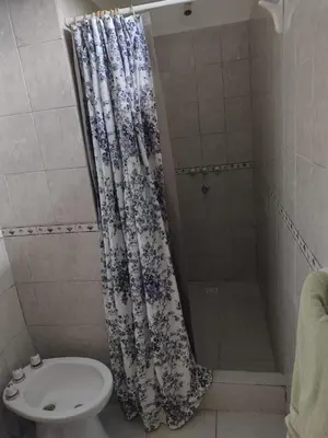 a bathroom with a shower with a toilet and a sink at La Calma, casa de Rio in Los Reartes