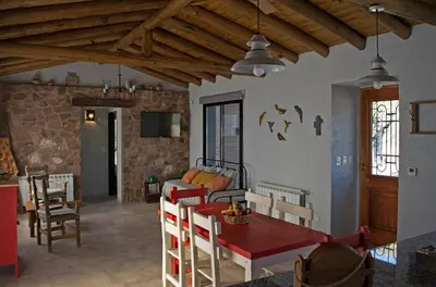 a living room with a table and a couch at Tintitacos in Los Hornillos