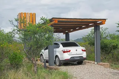 a white car parked under a wooden structure at Tintitacos in Los Hornillos