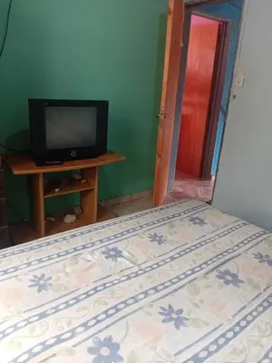 a bedroom with a bed and a tv on a table at La casita Tanti in Tanti Nuevo