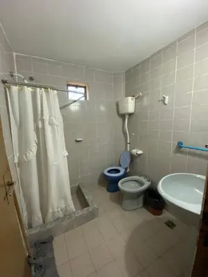 a bathroom with a toilet and a sink at Casa en complejo con pileta compartida in San Roque