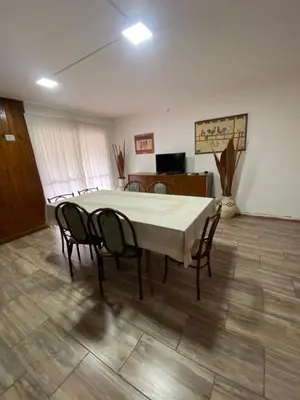 a dining room with a table and chairs in it at Casa en complejo con pileta compartida in San Roque