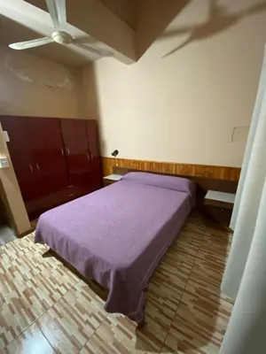a bedroom with a purple bed and a ceiling at Casa en complejo con pileta compartida in San Roque