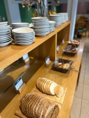 a display case with plates and bread on a table at Gran Lourdes Hotel in Villa Carlos Paz