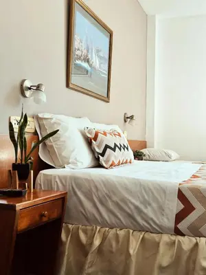 a bedroom with a bed and a table and a picture at Gran Lourdes Hotel in Villa Carlos Paz