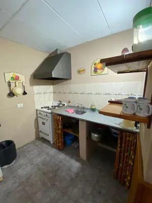 a kitchen with a sink and a counter top at Departamento con pileta compartida en complejo in San Roque