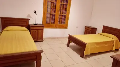 a bedroom with two beds and a window at Casona Boutique Córdoba-Habitaciones privadas in Cordoba