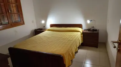 a bedroom with two beds and two night stands at Casona Boutique Córdoba-Habitaciones privadas in Cordoba