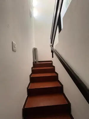 a staircase with wooden floors and a stair case at Casa del Centro in Santa Rosa de Calamuchita
