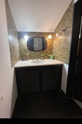 a bathroom with a sink and a mirror at Casa del Centro in Santa Rosa de Calamuchita