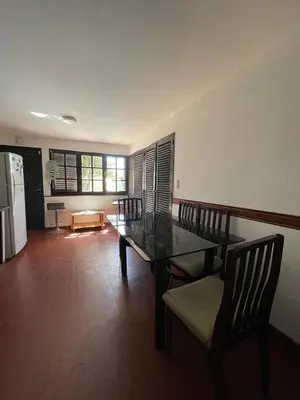 a dining room with a glass table and chairs at Casa del Centro in Santa Rosa de Calamuchita