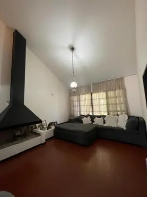 a large living room with a couch and a fireplace at Casa del Centro in Santa Rosa de Calamuchita