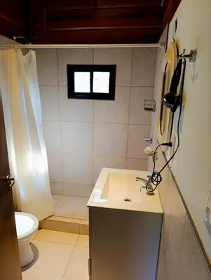 a bathroom with a sink and a toilet at CabañaReartes in Los Reartes