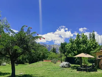 a garden with a table and an umbrella at Casa Los Naranjos in La Paz