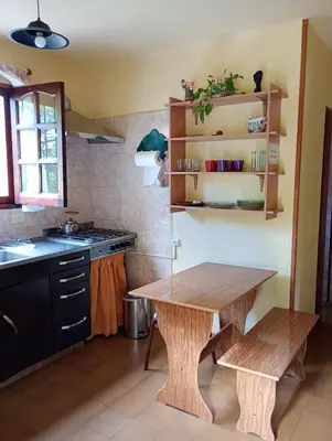 a kitchen with a wooden table and a sink at Casa Los Naranjos in La Paz
