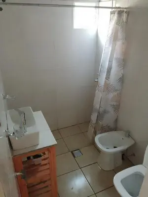 a bathroom with a sink and a toilet and a shower at Depto Calamuchita Rumipal in Villa Rumipal