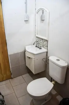 a bathroom with a white toilet and a sink at Monoambiente 3 personas in Río Segundo
