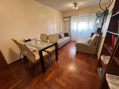 a living room with a table and a couch at Boulevard Uno in Cordoba