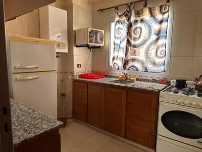 a small kitchen with a sink and a refrigerator at Boulevard Uno in Cordoba