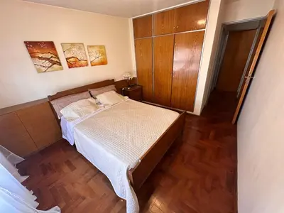 a small bedroom with a bed and a wooden floor at Boulevard Uno in Cordoba