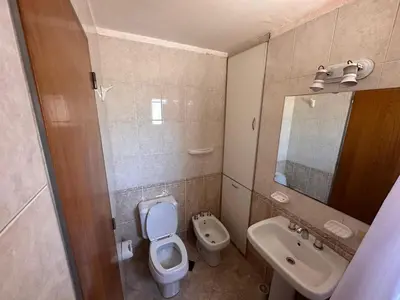 a bathroom with a toilet and a sink and a mirror at Boulevard Uno in Cordoba