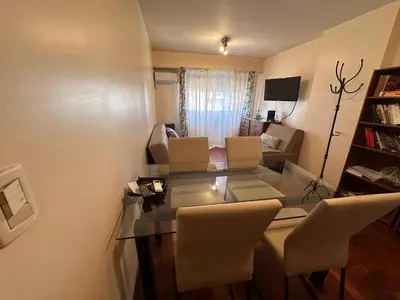 a living room with a glass table and chairs at Boulevard Uno in Cordoba