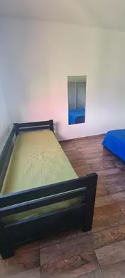 a bed sitting in a room with a mirror at Las liebres in San Lorenzo