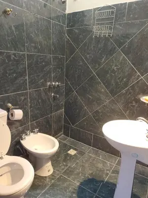 a bathroom with a toilet and a sink at Casas Los Nogales in Arroyo de Los Patos