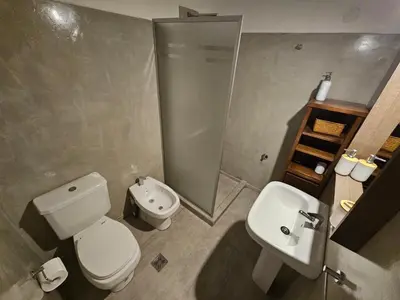 a bathroom with a white toilet and a sink at Departamento en B Gral Paz, a metros de Hospital Italiano in Cordoba