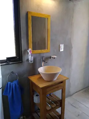 a bathroom with a bowl sink and a mirror at Villa Yacanto de Calamuchita in Villa Yacanto