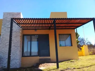 a small house with a red roof at Villa Yacanto de Calamuchita in Villa Yacanto