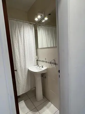 a bathroom with a sink and a mirror at Departamento Peatonal de Carlos Paz con Terraza Exclusiva in Villa Carlos Paz