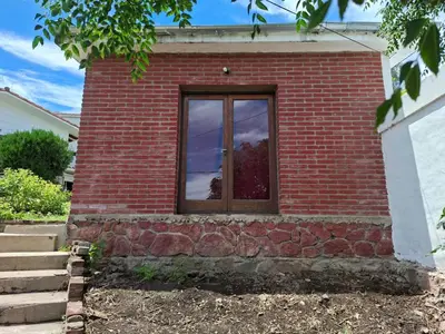 a brick building with a window on it at Casa con vision panoramica a 8 cuadras del centro in Villa Carlos Paz
