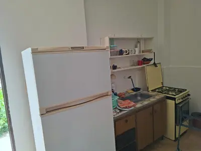 a kitchen with a white refrigerator and a sink at Casa con vision panoramica a 8 cuadras del centro in Villa Carlos Paz