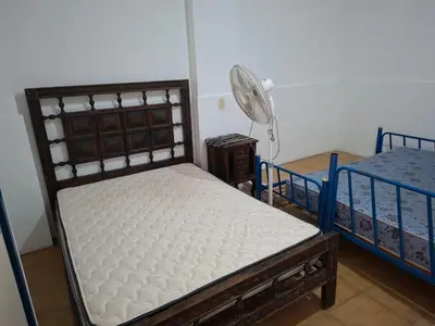 a bedroom with two beds and a fan at Casa con vision panoramica a 8 cuadras del centro in Villa Carlos Paz