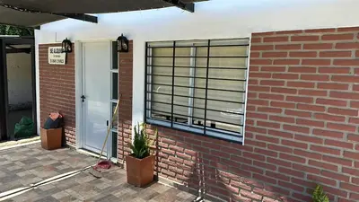 a brick house with a window and a door at Loft Cuesta Blanca in Cuesta Blanca