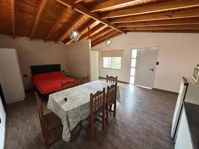 a living room with a table and a bed at Loft Cuesta Blanca in Cuesta Blanca