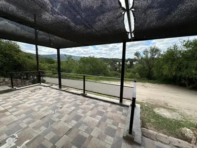 a balcony with a view of a tennis court at Loft Cuesta Blanca in Cuesta Blanca