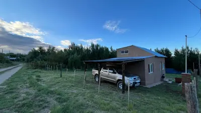 a truck parked in front of a small house at El limón in Villa Yacanto
