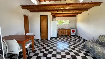 a kitchen with a table and a checkered floor at El limón in Villa Yacanto