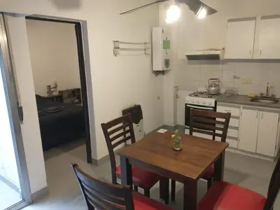 a kitchen and dining room with a table and chairs at Moderno departamento en pleno centro de Río Cuarto in Río Cuarto