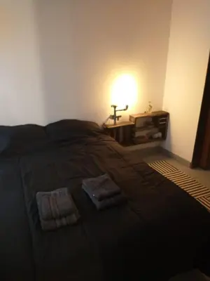a bedroom with a bed with two towels on it at Moderno departamento en pleno centro de Río Cuarto in Río Cuarto
