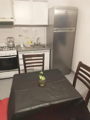 a kitchen with a table with a table cloth on it at Moderno departamento en pleno centro de Río Cuarto in Río Cuarto